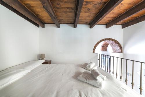 a bedroom with a white bed with white pillows at Porta Romana & Bocconi Cosy Apartment in Milan