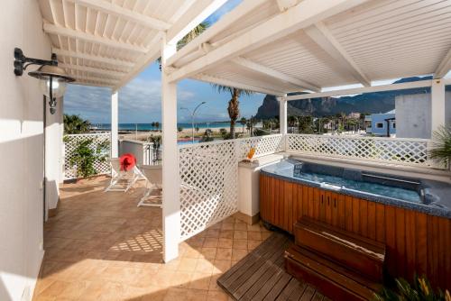 a hot tub on the balcony of a house at Hotel Ristorante Mediterraneo Faro in San Vito lo Capo