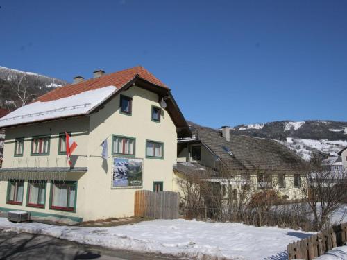 a house with a flag on it in the snow at Apartment in St Michael im Lungau near Katschberg in Sankt Michael im Lungau