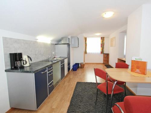a kitchen and dining room with a table and chairs at Chalet in Fiss near Ski Lifts in Fiss