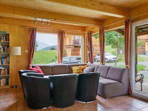 a living room with a couch and a window at Chalet in Sankt Georgen near ski area in Sankt Georgen ob Murau