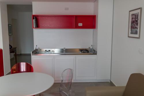 a kitchen with a sink and a red cabinet at Liberty Palace in Milazzo
