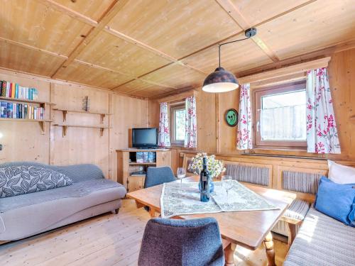 a living room with a couch and a table at Welcoming Holiday Home with Garden in Tyrol in Matrei in Osttirol