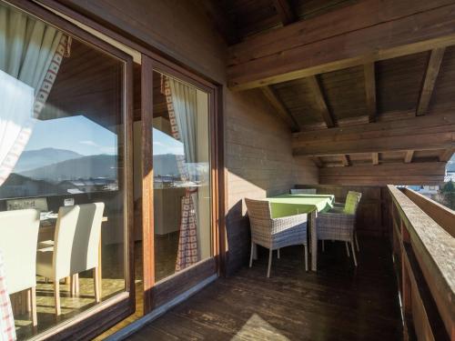 キルヒドルフ・イン・チロルにあるSunlit Apartment near Ski Area in Tyrolの家のバルコニー(テーブル、椅子付)