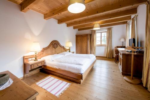 a bedroom with a large bed and a desk and a desk at Exklusiv Apartment Scheichl in Unterach am Attersee