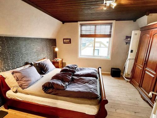 a bed in a room with a brick wall at 8 person holiday home in MÅLØY-By Traum in Måløy
