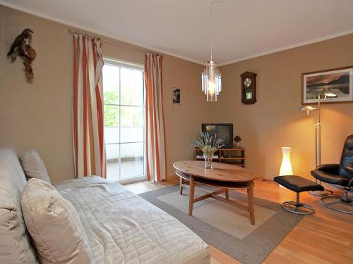 a living room with a couch and a table at Apartment with terrace in Salzburg in Lungötz