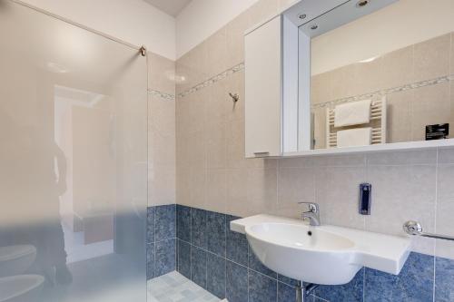 a bathroom with a sink and a mirror at Hotel Nettuno in Lido di Jesolo