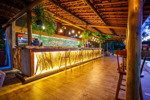 a bar with a row of stools in a restaurant at Eco Luar Boutique Hotel in Igarassu