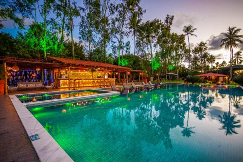 a swimming pool at a resort at night at Eco Luar Boutique Hotel in Igarassu