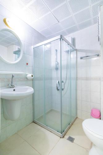 a bathroom with a glass shower and a sink at Interconti Apartments in Marmaris
