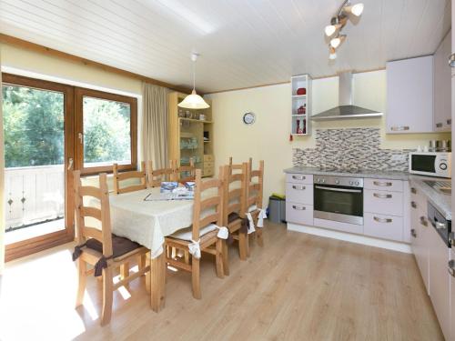 a kitchen and dining room with a table and chairs at Apartment in Salzburgerland near the ski area in Viehhofen