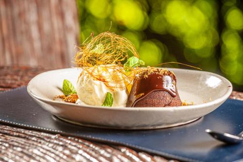 a plate of food with a dessert on a table at Eco Luar Boutique Hotel in Igarassu