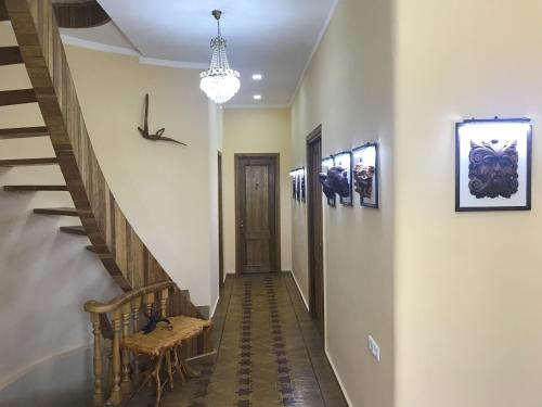 a hallway with stairs and a chandelier at Wooden Museum in Kutaisi