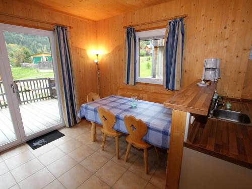 a kitchen with a table and chairs in a room at Chalet in Stadl an der Mur Styria near ski area in Stadl an der Mur