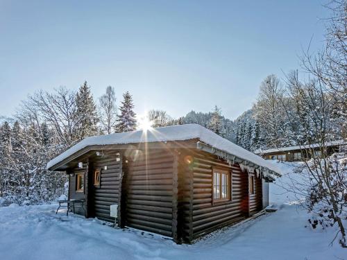 a log cabin with snow on the roof at Chalet in W rgl Boden near the ski area in Hopfgarten im Brixental
