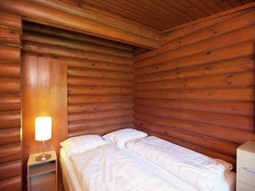 a room with a bed in a wooden room at Quaint Chalet in W rgl Boden with Terrace in Bad Häring