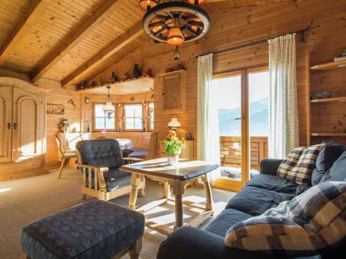 a living room with a couch and a table at Chalet in ski area in Piesendorf in Piesendorf