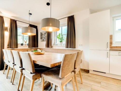 a kitchen and dining room with a wooden table and chairs at Chalet in Muehlbach am Hochkoenig with sauna in Mühlbach am Hochkönig