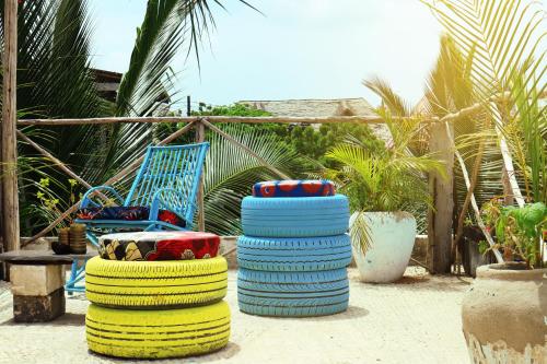 a stack of colorful tires next to a chair at Darwesh Nyumba Lodge in Nungwi