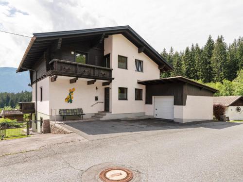 une maison blanche avec un toit noir dans l'établissement Holiday apartment in Koetschach Mauthen with sauna, à Kötschach-Mauthen