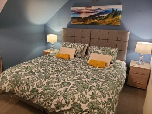 a bedroom with a large bed with two lamps at Carvetii - Mayhaven House - Tranquil Cul-de-Sac - 2 Bedrooms, Sleeps 4 Guests in Dunfermline