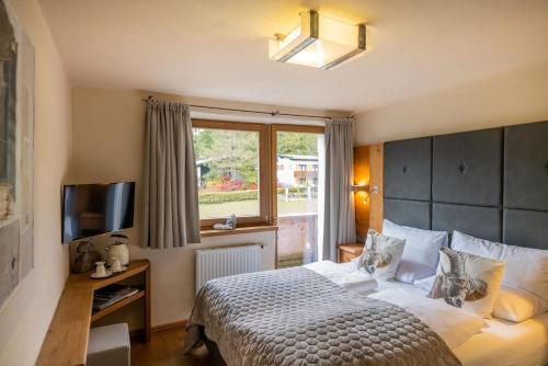 a hotel room with a bed and a window at Princess Bergfrieden in Seefeld in Tirol
