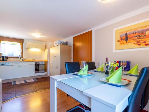 a kitchen and dining room with a white table and chairs at Simplistic Apartment in Piesendorf Walchen near Ski Slopes in Piesendorf