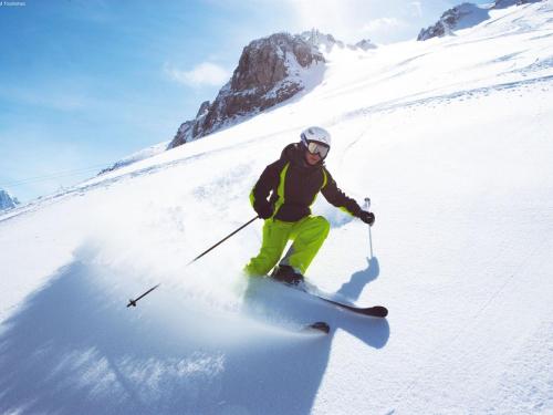 a person is skiing down a snow covered slope at Apartment in Walchen near Ski Slopes in Piesendorf