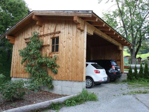 a small wooden building with a car parked in it at Apartment in Walchen near Ski Slopes in Piesendorf