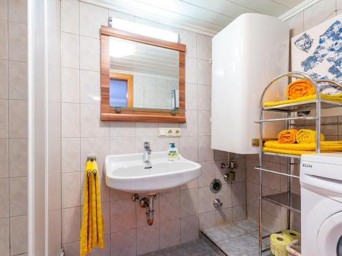 a bathroom with a sink and a mirror at Apartment in Walchen near Ski Slopes in Piesendorf