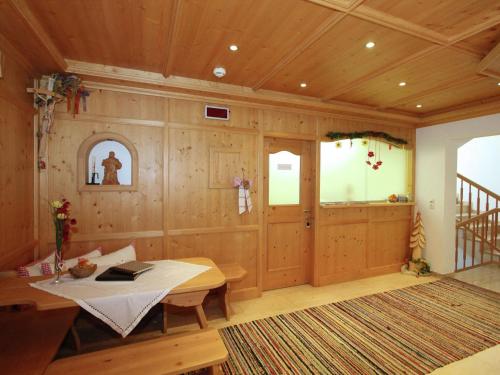 a room with wooden walls and a table and a staircase at Apartment in Kaltenbach near Ski Lift in Stumm
