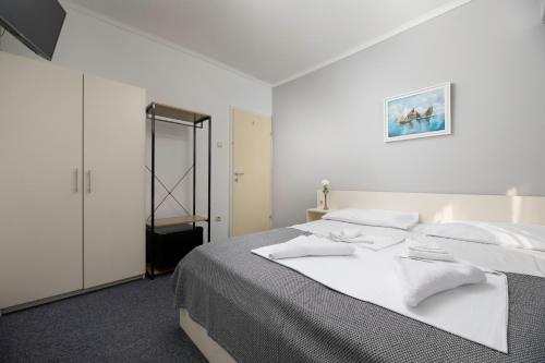 מיטה או מיטות בחדר ב-Meliores Rooms