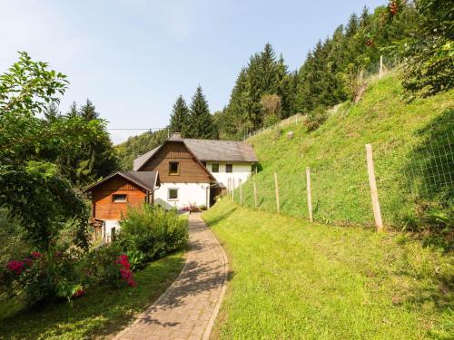 a house on a hill next to a dirt road at Apartment near the Koralpe ski area 