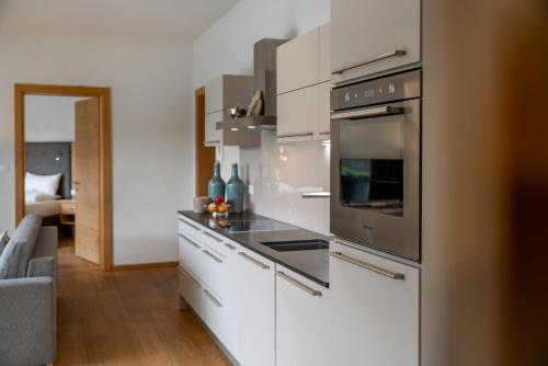 a kitchen with white cabinets and a stove top oven at Princess Bergfrieden in Seefeld in Tirol