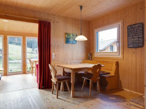 a dining room with a wooden table and chairs at Chalet in Hohentauern in the ski area in Hohentauern