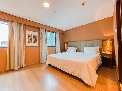 Een bed of bedden in een kamer bij Aconchegante Flat XI