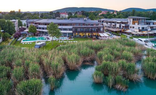 an aerial view of a resort with a river at Hotel Golden Lake Resort in Balatonfüred