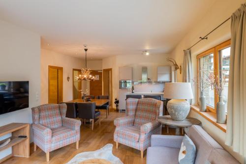 a living room with two chairs and a table at Princess Bergfrieden in Seefeld in Tirol