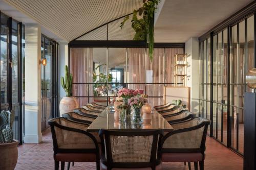 a dining room with a long table and chairs at One Hundred Shoreditch in London