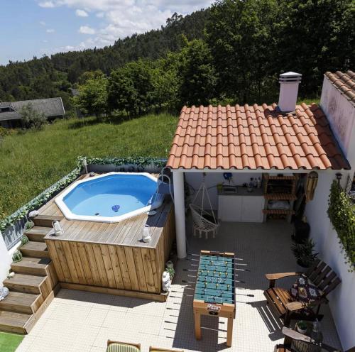 a backyard with a pool and a hot tub at Casa Do Bispo pereiro,Arganil in Coimbra