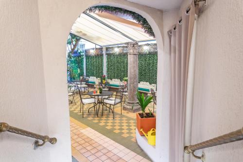 an arched doorway to a patio with a table and chairs at Hotel Medici in Rome