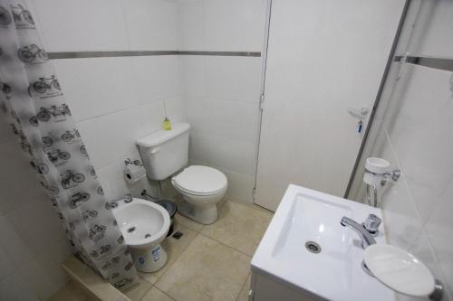 a bathroom with a toilet and a sink and a shower at Häuschen in Colonia San Miguel