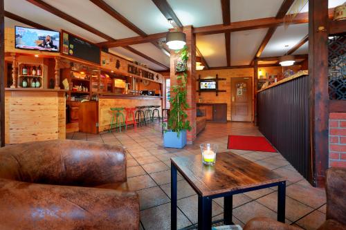 a restaurant with a table and a bar at Landhotel & Brauhaus Prignitzer Hof in Pritzwalk