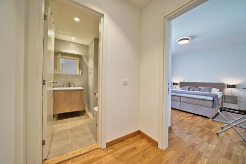 a bathroom with a sink and a bed in a room at Beograd na vodi - Belgrade Waterfront Riverside in Belgrade