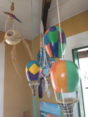 a bunch of colorful balloons hanging from a ceiling at Vila Beija-flor in Canoa Quebrada