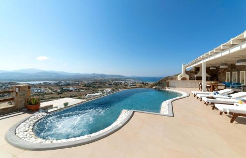 a swimming pool on the roof of a building at Naxos Rock Villas in Stelida