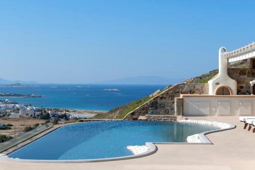 a swimming pool with a view of the ocean at Naxos Rock Villas in Stelida