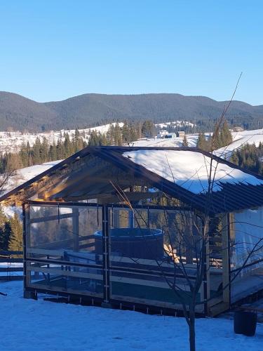 a gazebo with snow on top of it at Мелодія Гір Вид на гори in Vorokhta