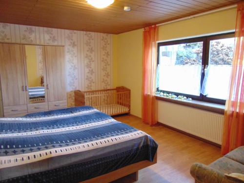 a bedroom with a bed and a large window at Ferienwohnung Astor zwischen Rhein und Mosel in Plaidt